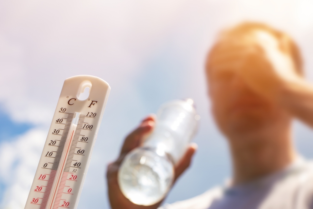 Man drinking water in extreme heat.